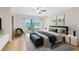 Serene bedroom with a large window offering natural light, hardwood floors, and contemporary decor at 25548 Pine Valley Dr, Mount Plymouth, FL 32776