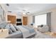 Bright main bedroom with plush carpet, ceiling fan, two armchairs, and natural light from the large window at 25548 Pine Valley Dr, Mount Plymouth, FL 32776