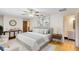 Beautiful main bedroom featuring wood floors, ceiling fan, and ensuite bathroom at 25548 Pine Valley Dr, Mount Plymouth, FL 32776