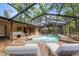 Covered patio featuring an inground pool with lounge chairs at 25548 Pine Valley Dr, Mount Plymouth, FL 32776