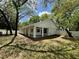 Rear elevation view of a home highlighting its covered porch and manicured lawn at 25721 Pinehurst St, Sorrento, FL 32776