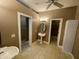 Well-lit bathroom with pedestal sink, tiled floor, and doorway to shower and closet provides convenience at 25721 Pinehurst St, Sorrento, FL 32776