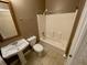 Bathroom with tiled floors, a bathtub with shower, and a white pedestal sink at 25721 Pinehurst St, Sorrento, FL 32776