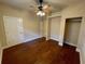 This bedroom features sleek wood floors, ceiling fan, and closet space at 25721 Pinehurst St, Sorrento, FL 32776
