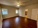 Spacious bedroom with wood-look flooring, bright windows and an en suite bathroom at 25721 Pinehurst St, Sorrento, FL 32776