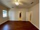 Spacious bedroom boasts wood tile flooring, neutral paint, and a window for ample natural lighting at 25721 Pinehurst St, Sorrento, FL 32776