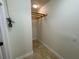 This closet features tile floors, neutral paint, and a storage shelf at 25721 Pinehurst St, Sorrento, FL 32776