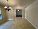 Open dining area with decorative tile flooring and classic lighting fixtures, leading to the living space at 25721 Pinehurst St, Sorrento, FL 32776