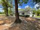Charming one-story home featuring a painted brick exterior, manicured hedges and a long driveway at 25721 Pinehurst St, Sorrento, FL 32776