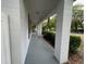 Inviting white brick front porch with large columns and a long, covered entryway, providing ample space at 25721 Pinehurst St, Sorrento, FL 32776