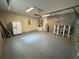 Spacious garage featuring painted floors, refrigerator, water heater, and storage space at 25721 Pinehurst St, Sorrento, FL 32776
