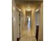 Hallway with tiled floors providing access to various rooms, enhancing the home's layout at 25721 Pinehurst St, Sorrento, FL 32776
