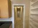Long hallway with tile floors and built-in shelving on the right at 25721 Pinehurst St, Sorrento, FL 32776