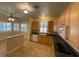 An open-concept kitchen with breakfast bar and views into an adjacent dining area with plantation shutters at 25721 Pinehurst St, Sorrento, FL 32776