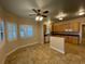 Bright eat-in kitchen with a ceiling fan, light cabinets, dark countertops and a breakfast bar at 25721 Pinehurst St, Sorrento, FL 32776