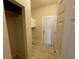 Bright laundry room featuring tile flooring, white cabinets, and a door to the exterior at 25721 Pinehurst St, Sorrento, FL 32776