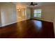 Spacious living room featuring hardwood floors, neutral walls, ceiling fan and large windows at 25721 Pinehurst St, Sorrento, FL 32776