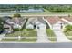 Aerial view of a single-Gathering home with a well-manicured front yard and close proximity to a lake at 2607 Quail Pond Way, Kissimmee, FL 34743