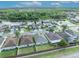 Attractive aerial view of residential houses in a Gathering neighborhood beside a tranquil lake and lush greenery at 2607 Quail Pond Way, Kissimmee, FL 34743