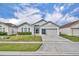 Charming single-story home features a well-maintained lawn and a two-car garage at 2607 Quail Pond Way, Kissimmee, FL 34743
