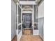 Inviting screened-in porch with tiled flooring, featuring a view of the decorative front door at 2607 Quail Pond Way, Kissimmee, FL 34743