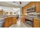 Kitchen view highlights stainless steel oven and microwave, granite countertops, and tile flooring at 2607 Quail Pond Way, Kissimmee, FL 34743