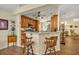 The kitchen area showcases a breakfast bar with seating and decorative elements throughout at 2607 Quail Pond Way, Kissimmee, FL 34743