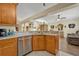 Kitchen view showcases stainless steel dishwasher, granite countertops, and open floorplan at 2607 Quail Pond Way, Kissimmee, FL 34743