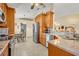 Modern kitchen with stainless appliances, wood cabinets, granite countertops, and breakfast nook at 2607 Quail Pond Way, Kissimmee, FL 34743