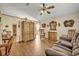 Spacious living room featuring wood-look tile flooring, rocking chair, and access to backyard at 2607 Quail Pond Way, Kissimmee, FL 34743