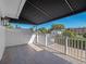 Inviting balcony with a black retractable awning, white railings, and a tranquil view of the neighborhood at 266 Chase Ave, Winter Park, FL 32789