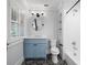 Bathroom with striking patterned tile floor, blue vanity, and modern fixtures at 266 Chase Ave, Winter Park, FL 32789