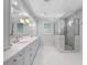 Elegant bathroom featuring double sinks, marble countertops, stylish fixtures, and a frameless glass shower at 266 Chase Ave, Winter Park, FL 32789