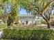 Stunning two-story white home with manicured landscaping, mature trees, and brick driveway at 266 Chase Ave, Winter Park, FL 32789