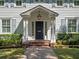 Elegant front door with sidelights and a hanging lantern, framed by manicured hedges at 266 Chase Ave, Winter Park, FL 32789