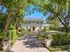 Charming home with manicured lawn, brick driveway, and lush landscaping creating curb appeal at 266 Chase Ave, Winter Park, FL 32789