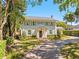 Beautiful two-story home with a brick driveway, lush landscaping, and classic architectural details at 266 Chase Ave, Winter Park, FL 32789