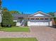 Garage exterior featuring a clean design, well-maintained landscaping, and a brick driveway at 266 Chase Ave, Winter Park, FL 32789