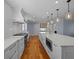 A gorgeous kitchen boasts white cabinetry, stainless appliances, a large island, and open floor plan at 266 Chase Ave, Winter Park, FL 32789