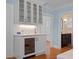 Kitchenette with a wine fridge, white cabinetry, and adjacent views of other rooms at 266 Chase Ave, Winter Park, FL 32789