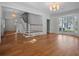 Sun-filled living room featuring hardwood floors, a staircase, and a large bay window with natural light at 266 Chase Ave, Winter Park, FL 32789
