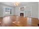 Elegant living room featuring hardwood floors, fireplace, and French doors providing an inviting ambiance at 266 Chase Ave, Winter Park, FL 32789