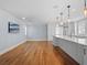 Open concept living room and kitchen area with hardwood floors and white cabinetry at 266 Chase Ave, Winter Park, FL 32789
