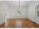 Spacious living room featuring hardwood floors, white walls, shuttered windows and a chandelier at 266 Chase Ave, Winter Park, FL 32789