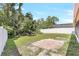 Large, grassy back yard with a patio area surrounded by mature trees at 271 Morning Glory Dr, Lake Mary, FL 32746