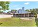View of the backyard, showcasing a screened-in patio and spacious lawn at 271 Morning Glory Dr, Lake Mary, FL 32746