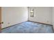 Neutral bedroom with blue carpet, white walls, and natural light from window at 271 Morning Glory Dr, Lake Mary, FL 32746