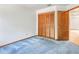 This bedroom has a spacious closet with wooden doors and blue carpeting at 271 Morning Glory Dr, Lake Mary, FL 32746
