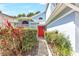 Inviting front entrance with a bright red door, framed by lush greenery, and an arched window above at 271 Morning Glory Dr, Lake Mary, FL 32746