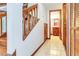 Inviting hallway with tile flooring leading to stairs and a half bathroom at 271 Morning Glory Dr, Lake Mary, FL 32746